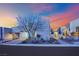 Modern home exterior features a multi car garage, desert landscaping, and brick driveway at 658 Falcon Summit Ct, Henderson, NV 89012