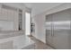 Bright kitchen with stainless steel refrigerator, wall oven, light wood cabinets and white countertops at 658 Falcon Summit Ct, Henderson, NV 89012