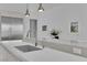 Bright kitchen featuring a large island, modern faucet, and stainless steel refrigerator at 658 Falcon Summit Ct, Henderson, NV 89012