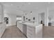 Modern kitchen boasts an island with white countertops, stainless steel appliances, and hardwood floors at 658 Falcon Summit Ct, Henderson, NV 89012