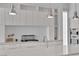 Modern kitchen with sleek white cabinets, stainless steel appliances, and a stylish backsplash at 658 Falcon Summit Ct, Henderson, NV 89012