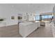 Bright, modern kitchen with large island, sleek white cabinetry, hardwood floors, and scenic views at 658 Falcon Summit Ct, Henderson, NV 89012