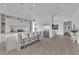 Modern kitchen features white cabinetry, sleek countertops, an island with seating, and hardwood floors at 658 Falcon Summit Ct, Henderson, NV 89012