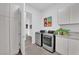 Well-organized laundry room equipped with modern washer and dryer, ample cabinet space, and sleek design for efficient chores at 658 Falcon Summit Ct, Henderson, NV 89012