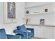 Bright sitting area featuring blue chairs, built in cabinets, and decor at 658 Falcon Summit Ct, Henderson, NV 89012