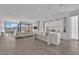 Open-concept living area with kitchen island, white decor, hardwood floors, and mountain views at 658 Falcon Summit Ct, Henderson, NV 89012