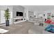 Bright open floor plan, light wood floors, fireplace and modern furnishing in large living room at 658 Falcon Summit Ct, Henderson, NV 89012