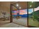 Living room opens to the patio with seating and city views through sliding glass doors at 658 Falcon Summit Ct, Henderson, NV 89012