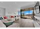 Open-concept living room with modern furnishings and seamless indoor-outdoor flow to a patio at 658 Falcon Summit Ct, Henderson, NV 89012