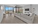 Bright, modern living room with a large white sofa, fireplace, and expansive windows offering scenic views at 658 Falcon Summit Ct, Henderson, NV 89012
