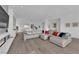 Spacious living room with a large comfortable sofa, hardwood floors, and bright lighting at 658 Falcon Summit Ct, Henderson, NV 89012