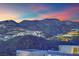 Stunning mountain view overlooking neighborhood homes at dusk at 658 Falcon Summit Ct, Henderson, NV 89012