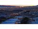 Scenic night view featuring hillside homes with city lights in the distance against a vibrant twilight sky at 658 Falcon Summit Ct, Henderson, NV 89012