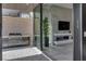 A stone patio leads to an outdoor kitchen and interior space with fireplace at 658 Falcon Summit Ct, Henderson, NV 89012