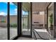 A stone patio showcases an outdoor kitchen with lush greenery nearby at 658 Falcon Summit Ct, Henderson, NV 89012
