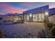 Private patio with fire pit, stylish seating, desert landscaping and seamless indoor/outdoor flow at 658 Falcon Summit Ct, Henderson, NV 89012