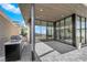 Outdoor patio with covered area, grill, and floor-to-ceiling windows offering scenic views at 658 Falcon Summit Ct, Henderson, NV 89012