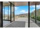 A covered patio with stone flooring offers stunning views of the mountains at 658 Falcon Summit Ct, Henderson, NV 89012