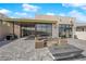 Modern patio boasts a fire pit, outdoor seating, and built-in grill, perfect for entertaining at 658 Falcon Summit Ct, Henderson, NV 89012