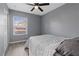 Cozy bedroom featuring neutral walls, ceiling fan, and natural light from the window at 6800 E Lake Mead Blvd # 1033, Las Vegas, NV 89156