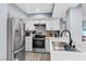 Bright kitchen featuring stainless steel appliances, white cabinets, and gray walls at 6800 E Lake Mead Blvd # 1033, Las Vegas, NV 89156