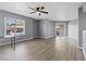 Bright living room with fan, window and sliding glass door with patio access at 6800 E Lake Mead Blvd # 1033, Las Vegas, NV 89156