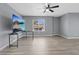 Living room boasts a fan, bright window and sleek laminate flooring at 6800 E Lake Mead Blvd # 1033, Las Vegas, NV 89156