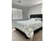 Relaxing bedroom with cozy carpeting, a large window with natural light, and a comfortable bed at 727 Pickled Pepper Pl, Henderson, NV 89011
