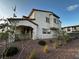 Inviting two-story home with desert landscaping, stucco exterior, and a tiled roof in a sunny neighborhood at 727 Pickled Pepper Pl, Henderson, NV 89011