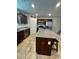 Well lit kitchen featuring stainless steel appliances, granite countertops and light tile flooring at 727 Pickled Pepper Pl, Henderson, NV 89011