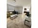 Spacious living area featuring tile flooring, lots of natural light, and open layout to dining area at 727 Pickled Pepper Pl, Henderson, NV 89011