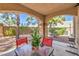 The backyard's covered patio has a dining table and barbeque for outdoor meals at 7270 Sheared Cliff Ln # 104, Las Vegas, NV 89149