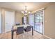 Inviting dining area with tiled floors, a modern chandelier, and sliding glass doors for outdoor access at 7270 Sheared Cliff Ln # 104, Las Vegas, NV 89149