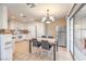 Bright dining area connected to the kitchen, featuring a stylish chandelier and modern appliances at 7270 Sheared Cliff Ln # 104, Las Vegas, NV 89149