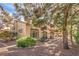 This exterior shows a two-story condo with a covered patio and landscaped yard at 7270 Sheared Cliff Ln # 104, Las Vegas, NV 89149