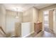 Upstairs hallway with hardwood floors, storage cabinet, and chandelier at 7270 Sheared Cliff Ln # 104, Las Vegas, NV 89149