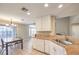 Bright eat-in kitchen with white cabinets and granite countertops, ideal for casual dining and meal preparation at 7270 Sheared Cliff Ln # 104, Las Vegas, NV 89149