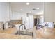 Well-lit kitchen featuring granite countertops and stainless steel sink, perfect for cooking and entertaining at 7270 Sheared Cliff Ln # 104, Las Vegas, NV 89149