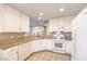 Well-equipped kitchen with white cabinets, granite countertops, and modern appliances at 7270 Sheared Cliff Ln # 104, Las Vegas, NV 89149