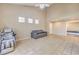 Open living room featuring tiled floors, a high ceiling, and a relaxing atmosphere with natural light at 7270 Sheared Cliff Ln # 104, Las Vegas, NV 89149