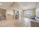 Bright living room with tiled floors, a staircase, and large windows offering a pleasant view at 7270 Sheared Cliff Ln # 104, Las Vegas, NV 89149
