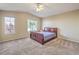 Vaulted ceiling main bedroom with plush carpet, a ceiling fan, and multiple windows for natural light at 7270 Sheared Cliff Ln # 104, Las Vegas, NV 89149
