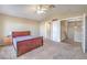 Carpeted main bedroom with vaulted ceilings, ceiling fan, ensuite bath and natural light at 7270 Sheared Cliff Ln # 104, Las Vegas, NV 89149