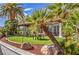 Charming outdoor seating area with covered tables, palm trees, and manicured landscaping at 7270 Sheared Cliff Ln # 104, Las Vegas, NV 89149