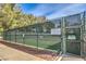 Tennis court with rules and regulations posted, offering a private recreational space at 7270 Sheared Cliff Ln # 104, Las Vegas, NV 89149