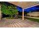 Inviting backyard featuring a covered patio, lush lawn, and mature landscaping at 7613 Hackensack Ct, Las Vegas, NV 89128