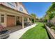 Picturesque backyard with a covered patio, lush greenery, and a serene atmosphere perfect for relaxation and enjoyment at 7613 Hackensack Ct, Las Vegas, NV 89128