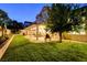 Expansive backyard with a covered patio, outdoor seating, and mature landscaping at 7613 Hackensack Ct, Las Vegas, NV 89128