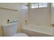 The bathroom features a white tub with tile surround and a window with natural lighting at 7613 Hackensack Ct, Las Vegas, NV 89128