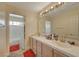 A spacious bathroom has a double vanity, tile countertop and opens to a separate toilet and shower at 7613 Hackensack Ct, Las Vegas, NV 89128